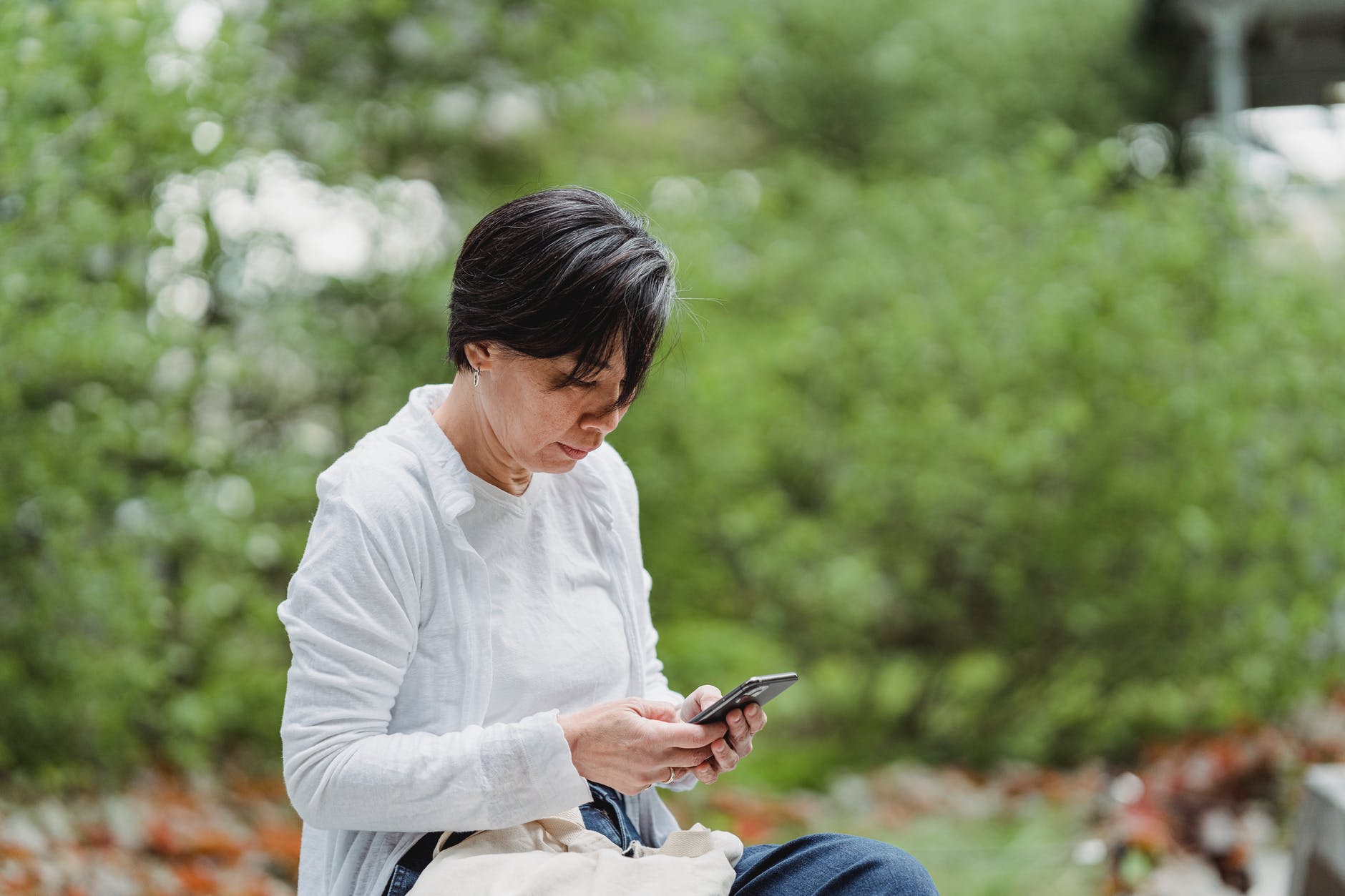 shallow focus photo of a woman using a smartphone